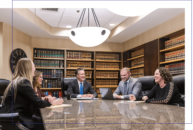 Photo of the firm's attorneys and staff sitting at a conference table